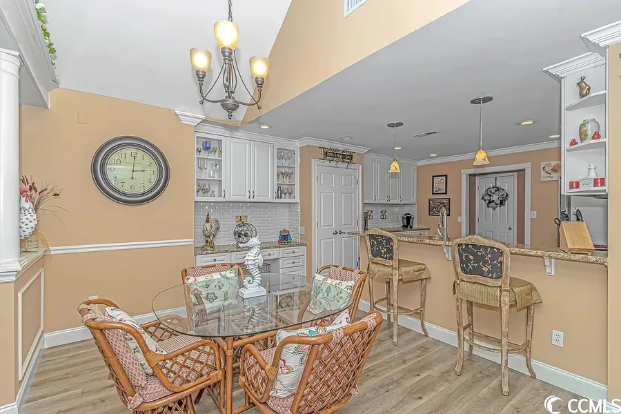 Open kitchen and dining area with breakfast bar